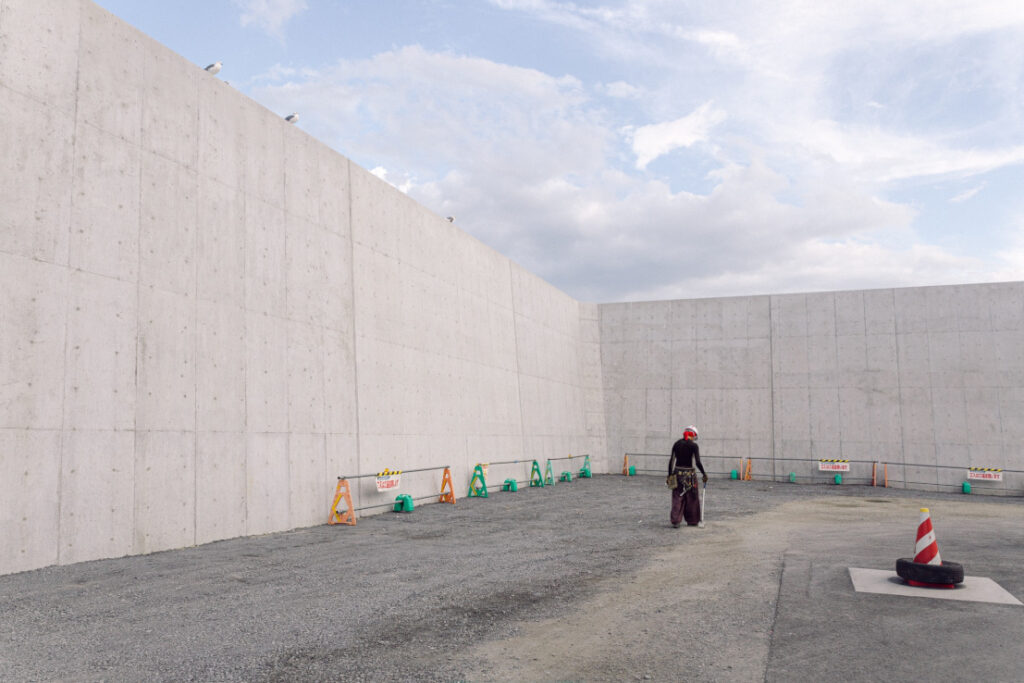 Monolithic seawall being constructed on the seafront to protect against tsunamis in Japan