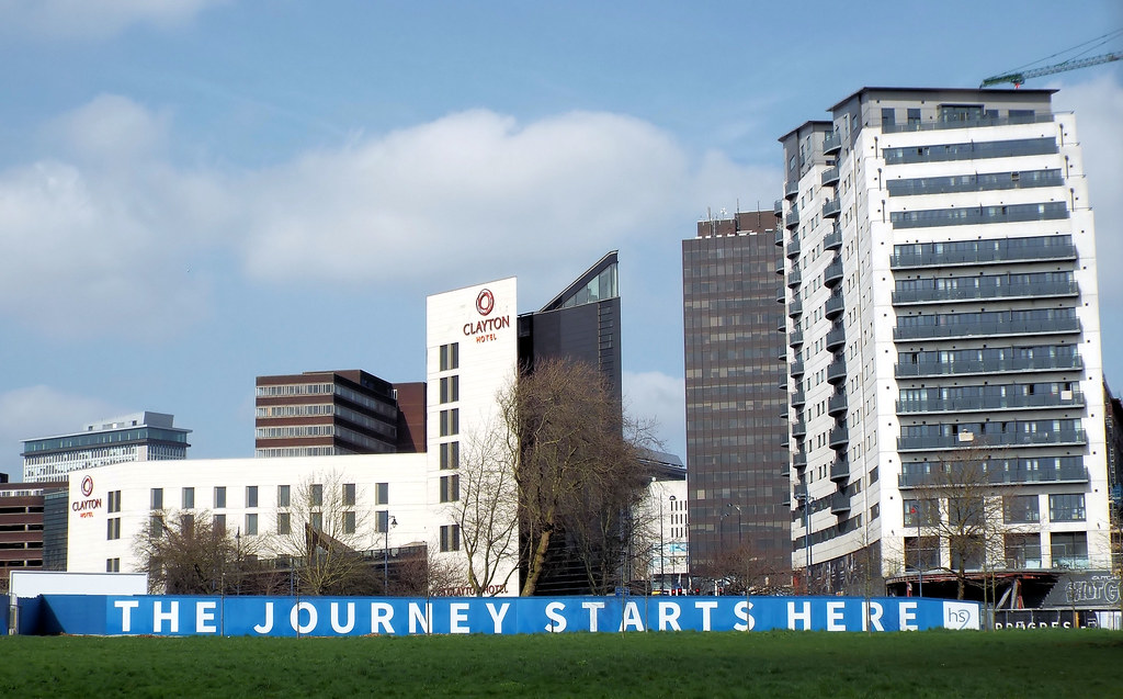 The Journey Starts Here reads a sign that symbolises the start of the HS2 development amongst high rise buildings